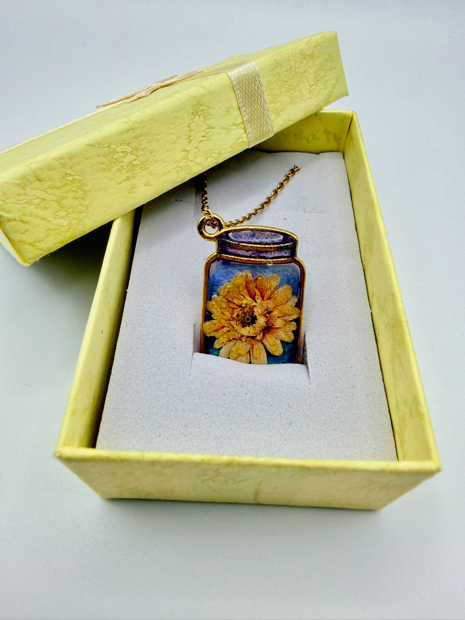 Golden Hour Garden handmade orange and gold bottle-shaped resin necklace
